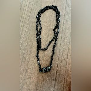 Black long necklace.